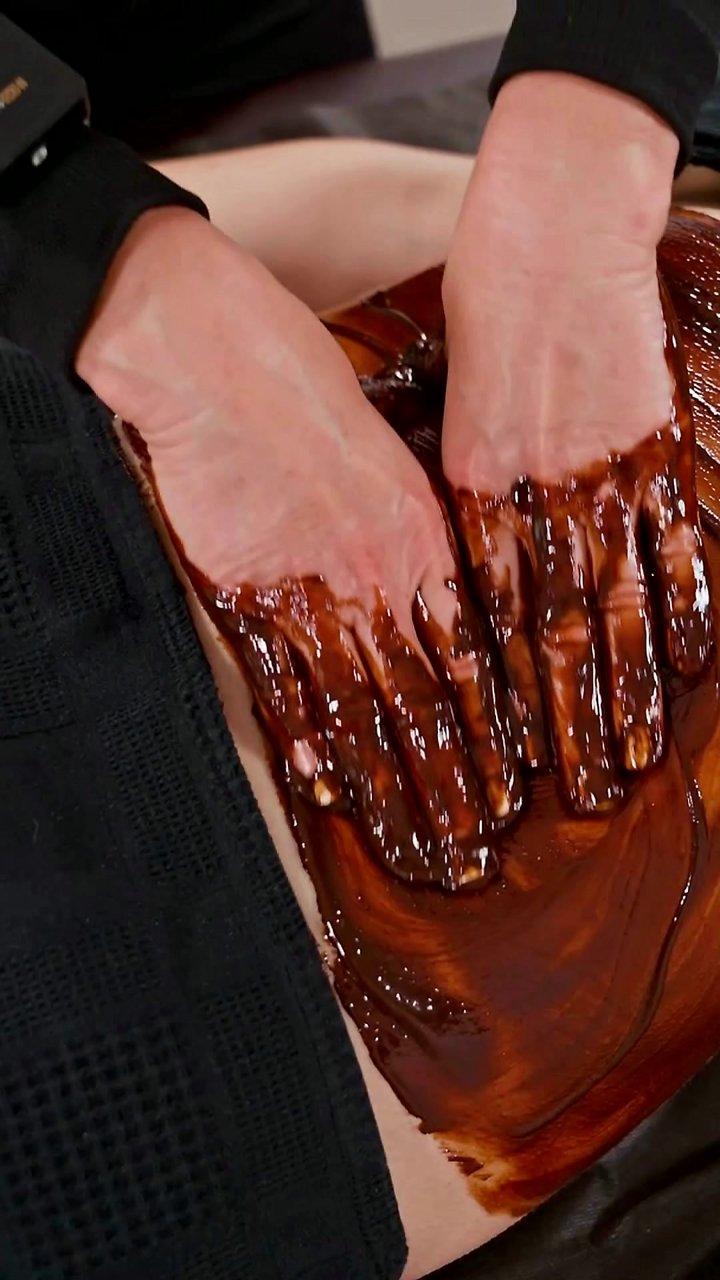 That ache in your lower back isn't from your chair—it's from deep tension, and this ASMR back massage is the only way out. A rich chocolate wrap is worked into the lumbar spine and glutes, warming the muscles with each slow pass. This treatment targets th